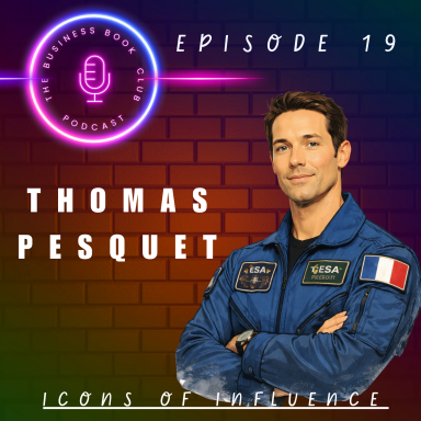 Portrait of astronaut Thomas Pesquet in a blue flight suit with a microphone graphic background.