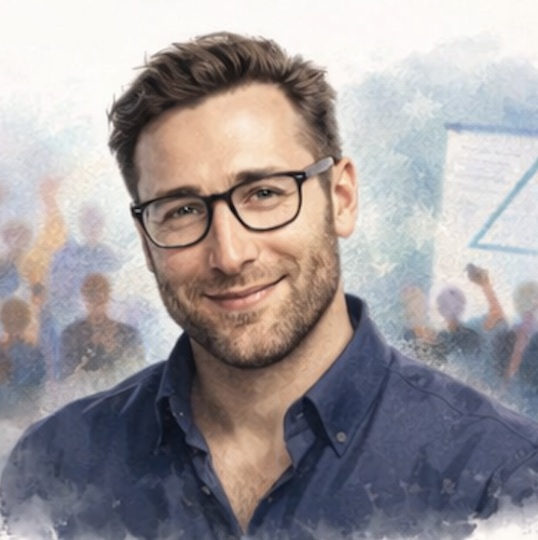 Smiling man in glasses with a blurred audience and presentation in the background. Simon Sinke