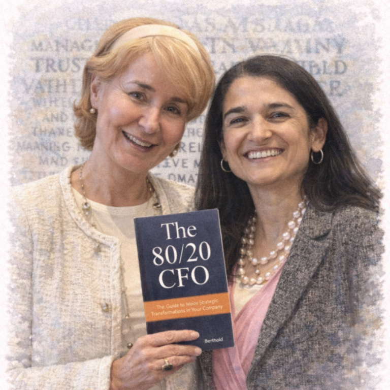 Two women smiling together, holding a book titled "The 80/20 CFO."
